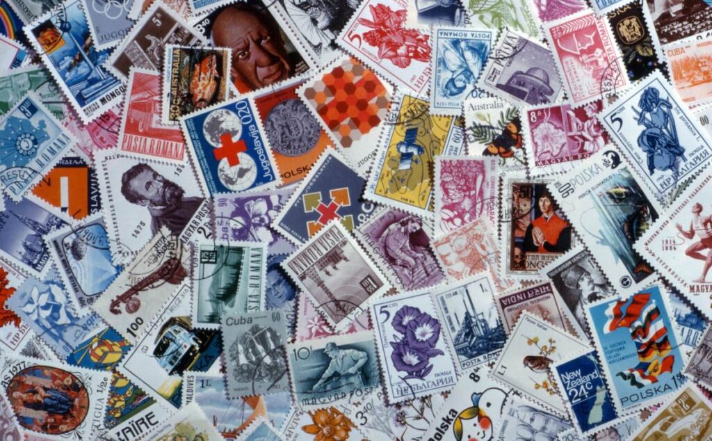 a pile of postage stamps from around the world.